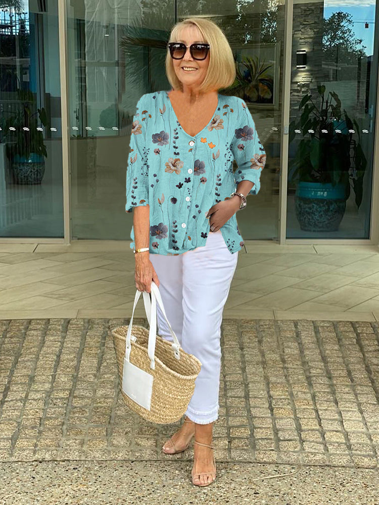 Bella women's blouse with three-quarter sleeves and a V-neckline featuring button closure, perfect for versatile styling and comfortable wear. 0