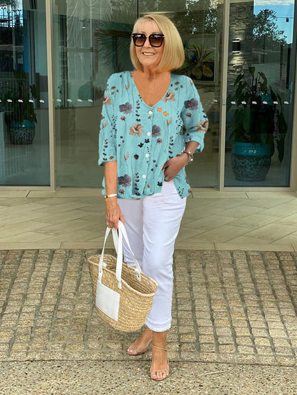 Bella women's blouse with three-quarter sleeves and a V-neckline featuring button closure, perfect for versatile styling and comfortable wear. 0
