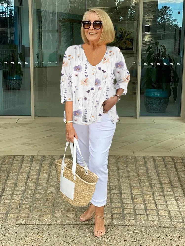 Bella women's blouse with three-quarter sleeves and a V-neckline featuring button closure, perfect for versatile styling and comfortable wear. 2