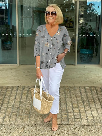 Bella women's blouse with three-quarter sleeves and a V-neckline featuring button closure, perfect for versatile styling and comfortable wear. 3